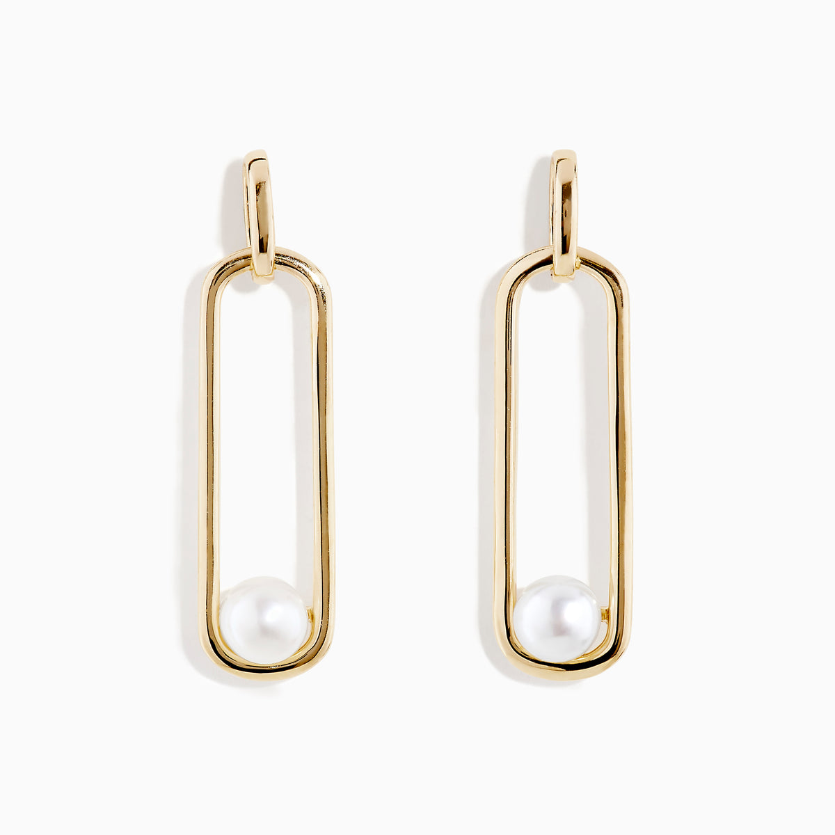 The 14K Yellow Gold Paperclip Cultured Freshwater Pearl Earrings feature elongated oval hoops in yellow gold, each adorned with a single freshwater pearl at the bottom, displayed on a plain white background.