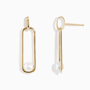 The 14K Yellow Gold Paperclip Cultured Freshwater Pearl Earrings feature elongated oval hoops in yellow gold, each adorned with a single freshwater pearl at the bottom, displayed on a plain white background.