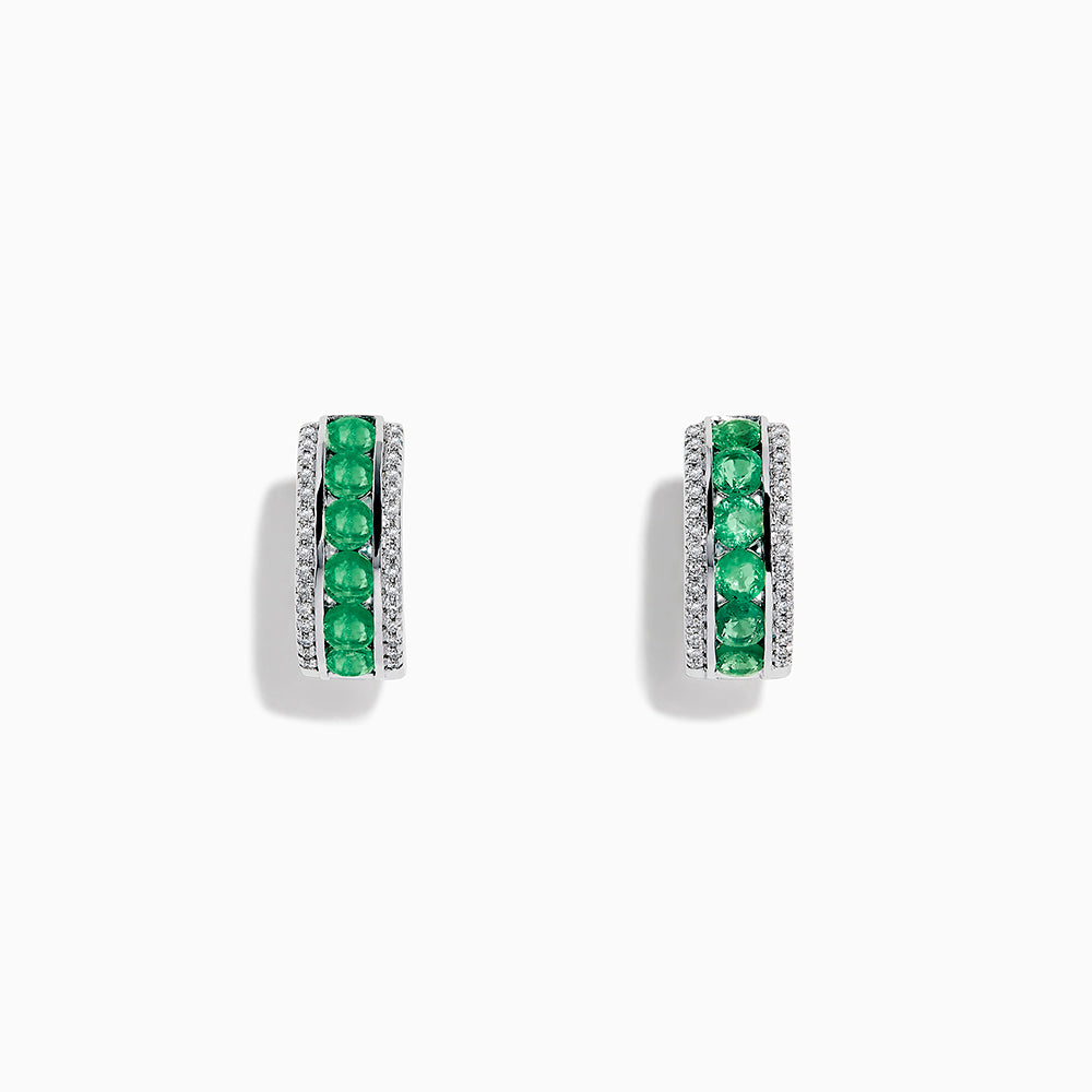 A pair of 14k White Gold Emerald and Diamond Huggie Hoop Earrings, 1.51 TCW, featuring a row of emeralds between two rows of diamonds, displayed on a plain white background.