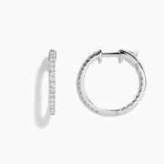 A pair of 14K White Gold 3/4 Diamond Hoop Earrings, thin and encrusted with sparkling diamonds, displayed vertically on a white background with soft shadows.