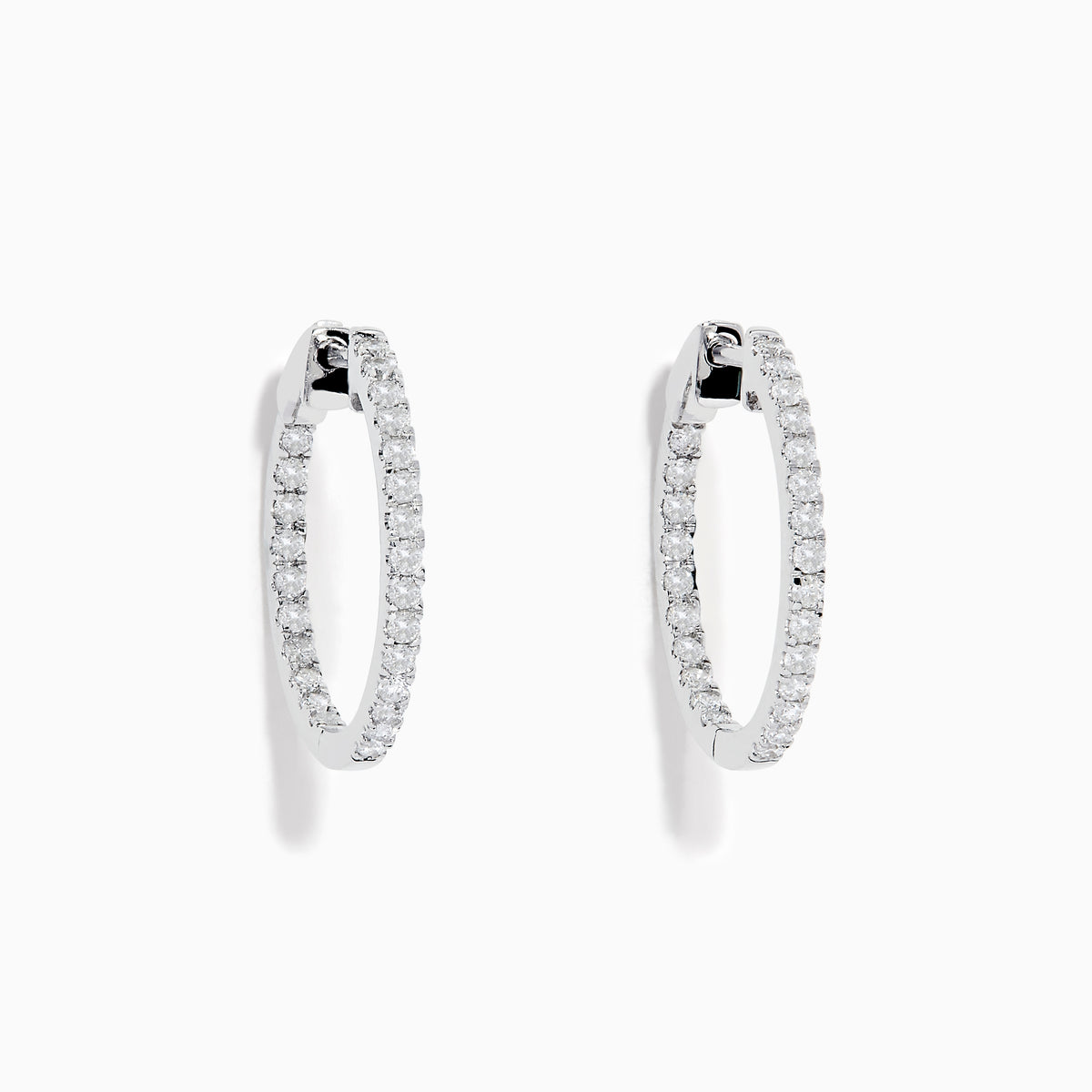 A pair of 14K White Gold 3/4 Diamond Hoop Earrings, thin and encrusted with sparkling diamonds, displayed vertically on a white background with soft shadows.