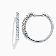 The 925 Sterling Silver Diamond Hoop Earrings, featuring small round diamonds totaling 0.24 TCW, are displayed upright on a white background to showcase the sparkling stones along the front edge.