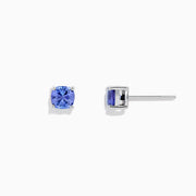 The Nahla Siri Sterling Silver Tanzanite Stud Earrings, 0.95 TCW, feature square-cut vibrant blue tanzanite gemstones set in simple prongs and are displayed against a plain white background.