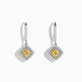 The Canare 18K Two-Tone Gold Cushion Shaped Double Halo Yellow Diamond Drop Earrings feature a square yellow diamond center, two halos of white diamonds, and a diamond-encrusted hoop for an elegant look.
