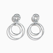 The Classique 14K White Gold Diamond Drop Earrings, 1.12 TCW, showcase two interlocking circles— the larger ones adorned with sparkling diamonds— presented against a plain white background.