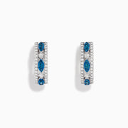 The Bella Bleu 14K White Gold Blue and White Diamond Small Hoop Earrings showcase three marquise-shaped clusters of blue and white diamonds set along the front.