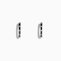 A pair of 14K white gold hoop earrings with black and white diamonds totaling 0.45 TCW, showcased against a plain white background. Effy craftsmanship enhances the modern elegance of this striking jewelry piece.