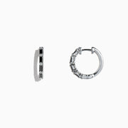 A pair of 14K white gold hoop earrings with black and white diamonds totaling 0.45 TCW, showcased against a plain white background. Effy craftsmanship enhances the modern elegance of this striking jewelry piece.