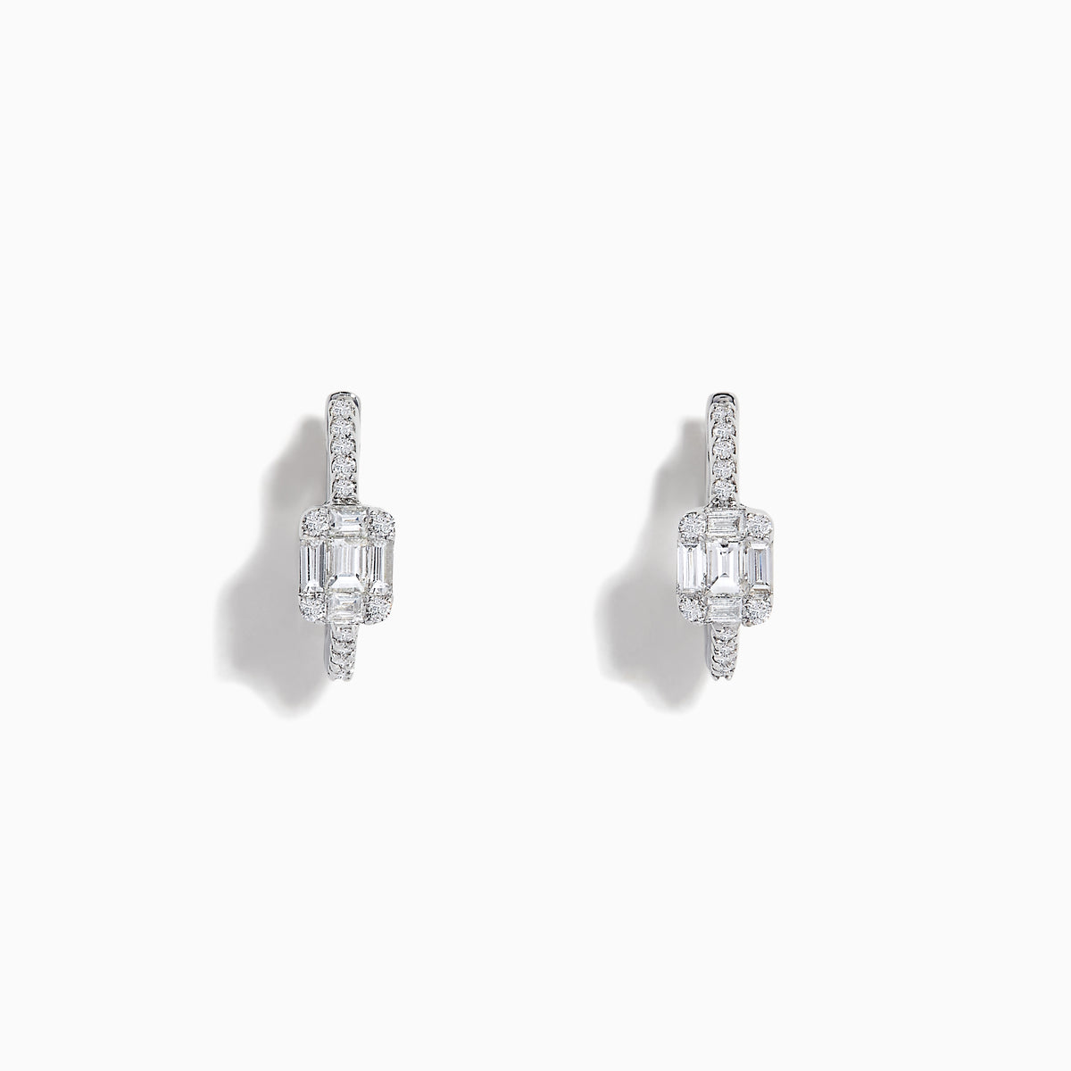 The Classique 14K White Gold Diamond 1/2 Huggie Earrings (0.49 TCW) feature elegant rectangular emerald-cut and round diamonds set in white gold hoops, displayed on a white background.