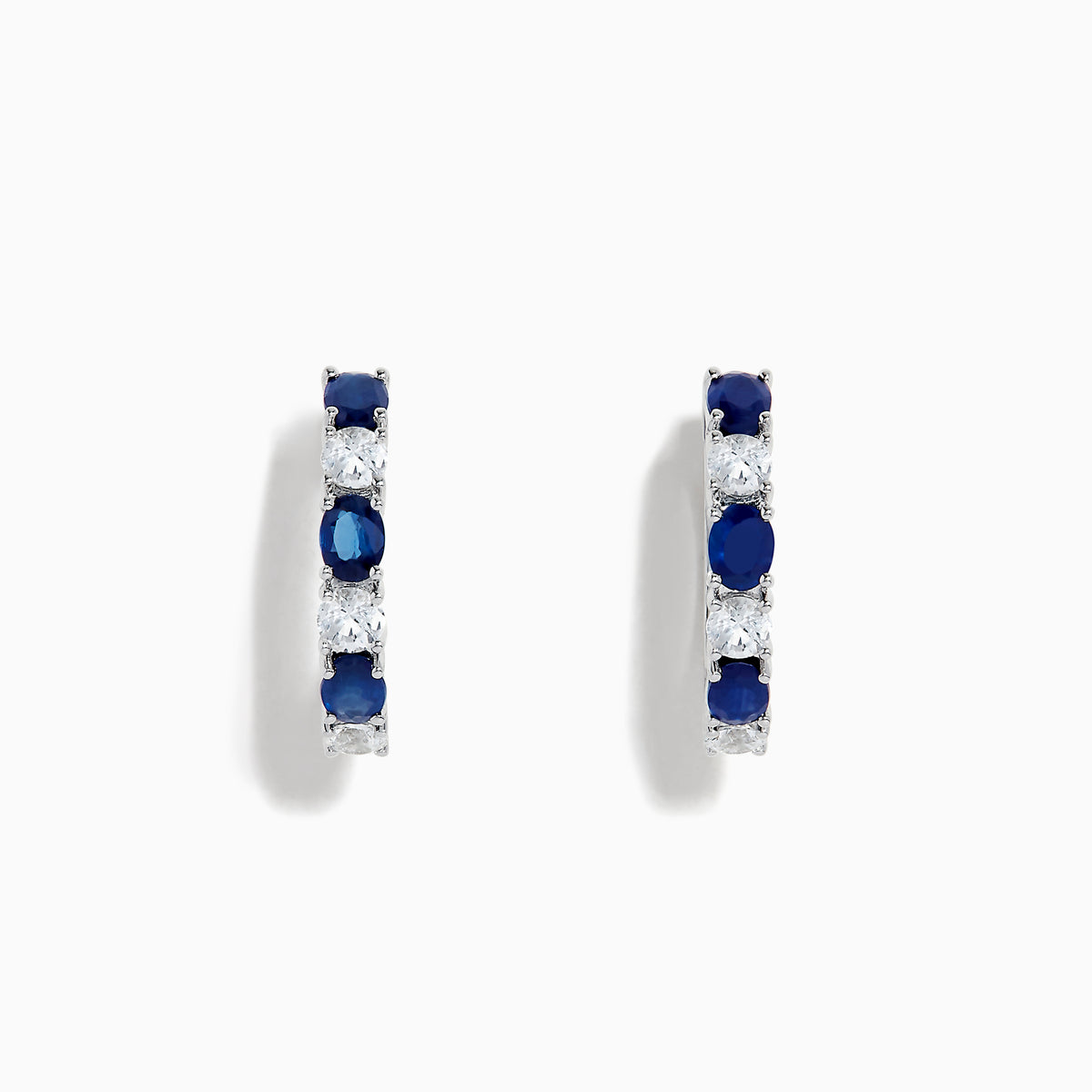 14K White Gold Multi Sapphire Hoop Earrings with alternating round blue sapphires and clear stones, shown on a white background.