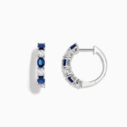 14K White Gold Multi Sapphire Hoop Earrings with alternating round blue sapphires and clear stones, shown on a white background.