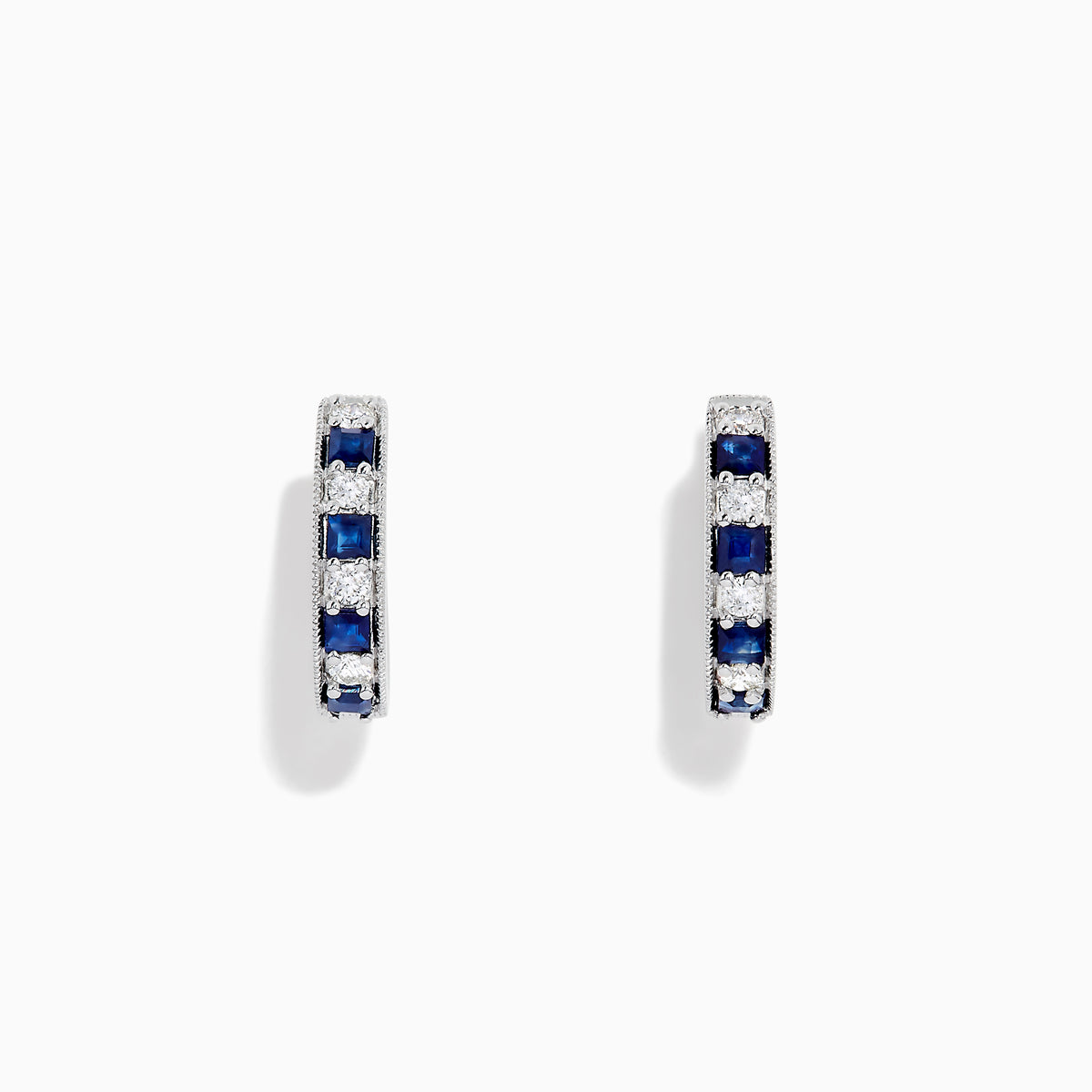 The Royale Bleu 14K White Gold Sapphire and Diamond Hoop Earrings feature alternating sapphire and diamond stones set in white gold, shown against a plain white background.