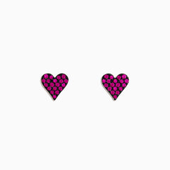 A pair of 14K Rose Gold Ruby Pave Heart Stud Earrings with bright pink gemstones is shown on a plain white background.
