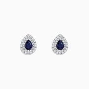 Royale Bleu 14K White Gold Pear Shaped Sapphire and Diamond Stud Earrings (2.23 TCW) feature dark blue sapphires at the center, encircled by two rows of sparkling diamonds in a white gold setting.