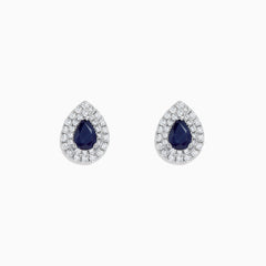 Royale Bleu 14K White Gold Pear Shaped Sapphire and Diamond Stud Earrings (2.23 TCW) feature dark blue sapphires at the center, encircled by two rows of sparkling diamonds in a white gold setting.