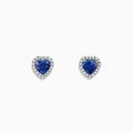 Nahla Siri 14K White Gold Tanzanite and Diamond Heart Earrings, 1.51 TCW, feature heart-shaped blue tanzanite gems bordered by sparkling diamonds. Shown on a plain white background.