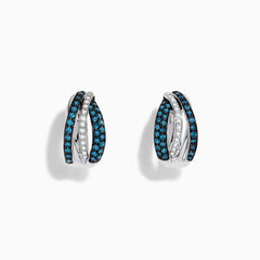 The Bella Bleu 14K White Gold White and Blue Diamond Mini Hoop Earrings feature intertwined bands with sparkling blue and clear stones, reminiscent of blue diamond earrings, shown on a white background.