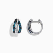 The Bella Bleu 14K White Gold White and Blue Diamond Mini Hoop Earrings feature intertwined bands with sparkling blue and clear stones, reminiscent of blue diamond earrings, shown on a white background.