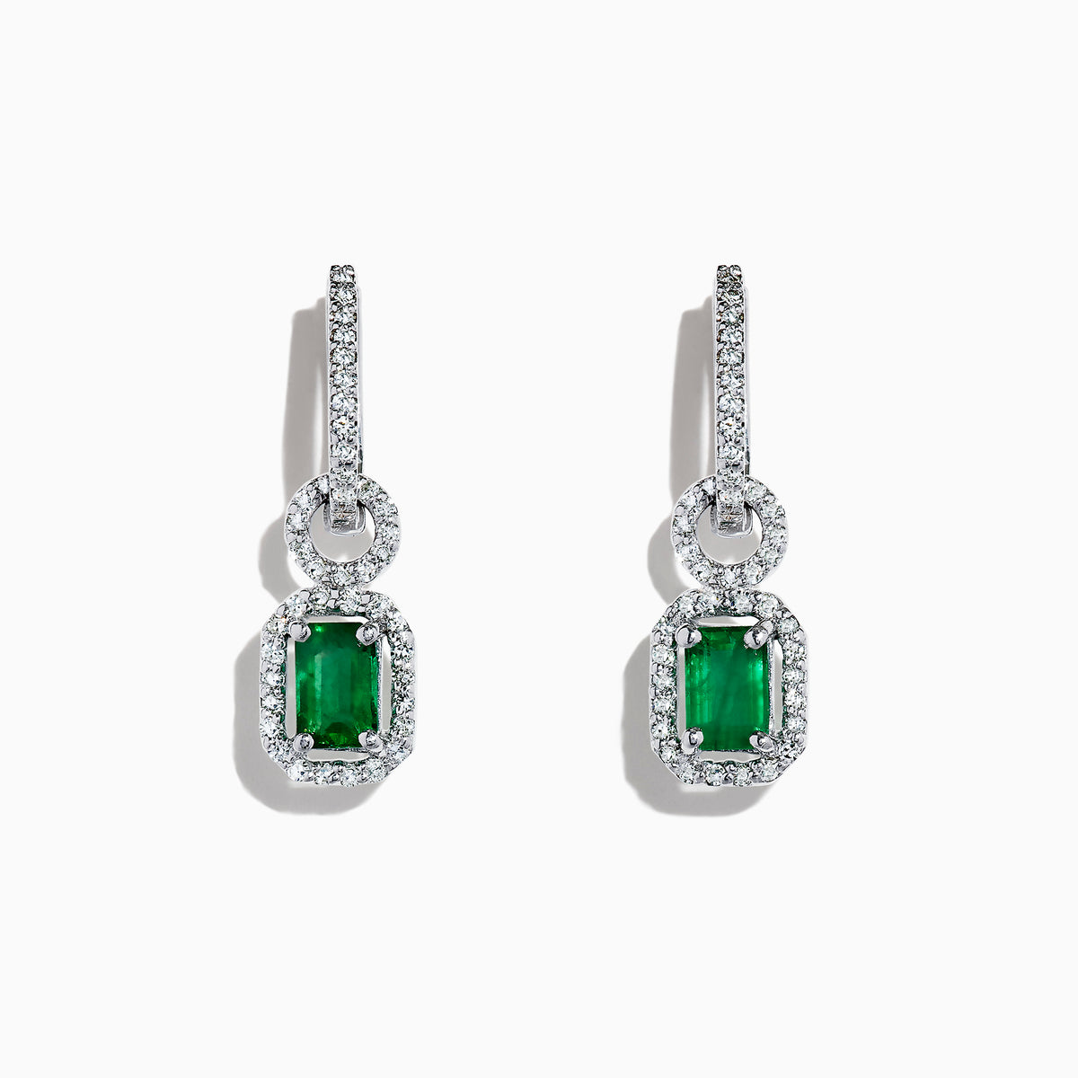 The Brasilica 14K White Gold Emerald and Diamond Drop Earrings, 1.47 TCW, feature rectangular gemstones in an elegant drop design, beautifully displayed on a white background.