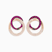 The Ruby Royale 14K Rose Gold Ruby and Diamond Intertwined Circles Earrings feature overlapping loops—one shimmering with diamonds, the other with vibrant rubies—for an elegant, interlocking design.