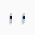 The Royale Bleu 14K White Gold Sapphire and Diamond Earrings feature a rectangular blue sapphire center accented by sparkling diamonds, presented against a plain white background.