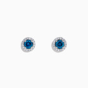 The Bella Bleu 14K Gold Blue and White Diamond Stud Earrings (0.71 TCW) feature deep blue stones surrounded by white diamonds, set in elegant gold and shown against a plain white background.