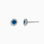 The Bella Bleu 14K Gold Blue and White Diamond Stud Earrings (0.71 TCW) feature deep blue stones surrounded by white diamonds, set in elegant gold and shown against a plain white background.