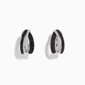 A pair of 14K White Gold White and Black Diamond Hoop Earrings featuring intertwined bands with black and clear stones, set against a white background.