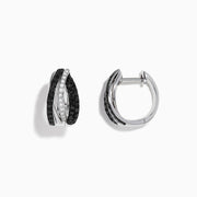 A pair of 14K White Gold White and Black Diamond Hoop Earrings featuring intertwined bands with black and clear stones, set against a white background.