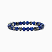 The Mens Lapis Lazuli and Hematite Beaded 7.5 Bracelet features round blue lapis lazuli stones, faceted hematite beads, and silver spacers on an elastic band, totaling 60.00 TW, displayed against a white background.