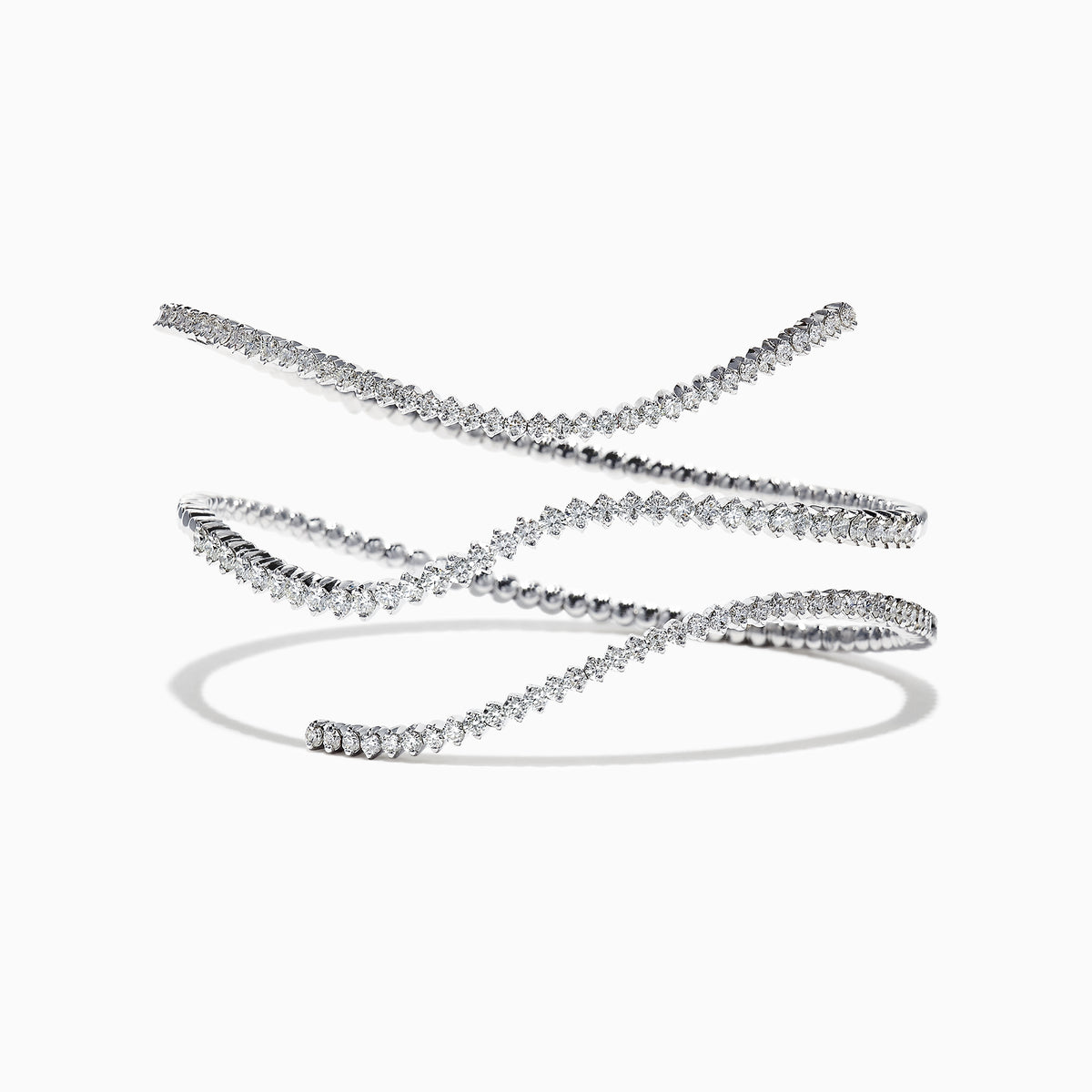 The Pave Classica 14K White Gold Diamond Wrap Bracelet, 3.43 TCW, coils elegantly in midair against a white background, casting a soft shadow and showcasing round-cut diamonds set closely along its length.