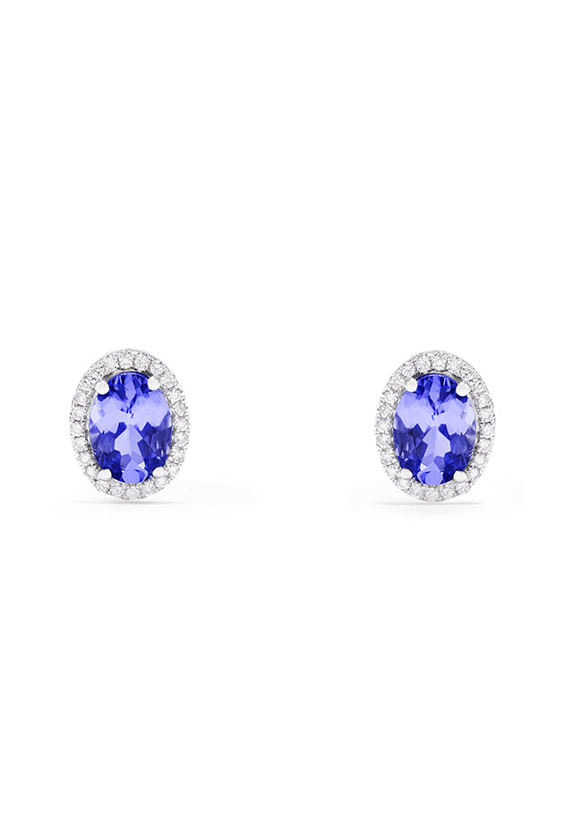 A pair of 14K white gold tanzanite and diamond stud earrings, 2.20 TCW, featuring vibrant oval blue tanzanites each encircled by sparkling diamonds.