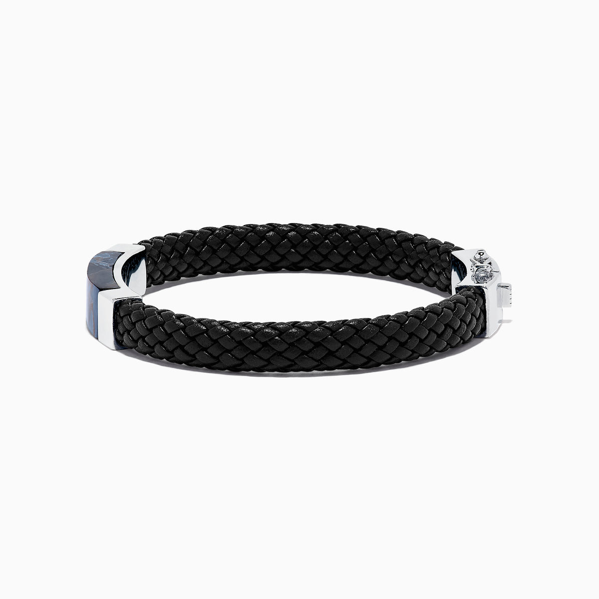 The Mens Sterling Silver Pietersite Woven Leather Bracelet, 12.50 TCW, features black woven leather, a sterling silver clasp, and a rectangular silver accent with a dark blue pietersite marbled center, shown on a white background.