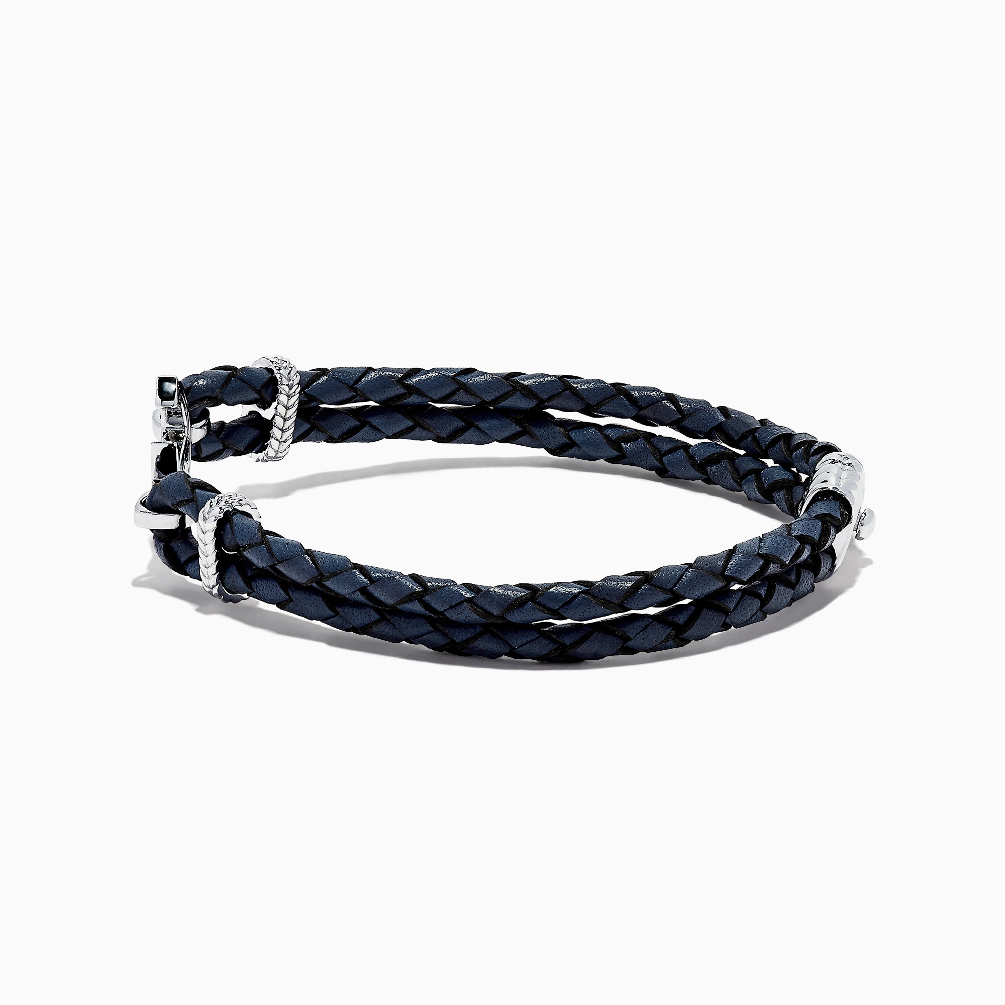 The Mens Sterling Silver Woven Leather Sapphire Anchor Bracelet, 0.52 TCW, features navy blue braided leather and a sterling silver anchor clasp set with sapphire gemstones.