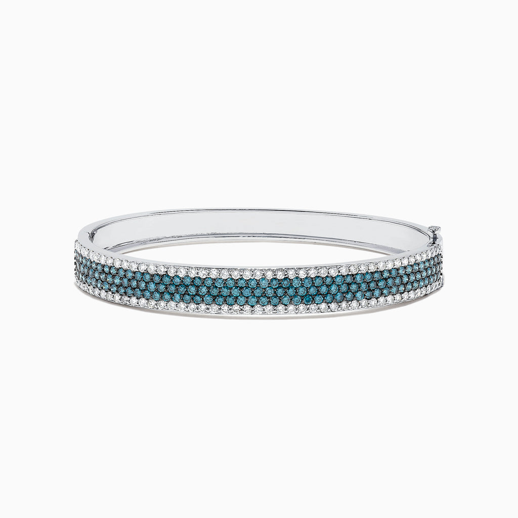 The Bella Bleu 14K White Gold Blue and White Diamond Bangle, 4.47 TCW, features three rows of round blue diamonds in the center, bordered by white diamonds along the edges, showcased on a plain white background.
