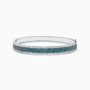 The Bella Bleu 14K White Gold Blue and White Diamond Bangle, 4.47 TCW, features three rows of round blue diamonds in the center, bordered by white diamonds along the edges, showcased on a plain white background.