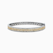 The Canare 14K Gold Yellow and White Diamond Bangle, 3.40 TCW, showcases a central row of yellow and white diamonds in an elegant geometric design inspired by Effy—an eye-catching gold statement piece.
