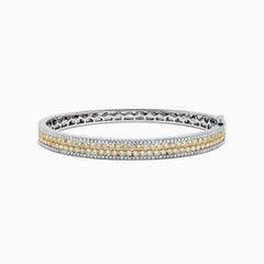 The Canare 14K Gold Yellow and White Diamond Bangle, 3.40 TCW, showcases a central row of yellow and white diamonds in an elegant geometric design inspired by Effy—an eye-catching gold statement piece.
