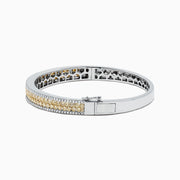 The Canare 14K Gold Yellow and White Diamond Bangle, 3.40 TCW, showcases a central row of yellow and white diamonds in an elegant geometric design inspired by Effy—an eye-catching gold statement piece.