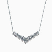 The 925 Sterling Silver Diamond Necklace features a V-shaped pendant with two rows of round diamonds, set at the chain’s base for maximum brilliance and a total carat weight of 0.47 TCW.