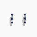 The Royale Bleu 14K Gold Sapphire and Diamond Hoop Earrings (1.19 TCW) feature alternating round sapphires and diamonds set in white gold, shown against a plain white background.