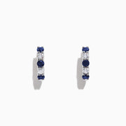 The Royale Bleu 14K Gold Sapphire and Diamond Hoop Earrings (1.19 TCW) feature alternating round sapphires and diamonds set in white gold, shown against a plain white background.