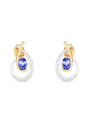 Elegant 14K two-tone gold earrings featuring a central oval tanzanite and a row of diamonds along the lower swirl, totaling 1.03 carats.