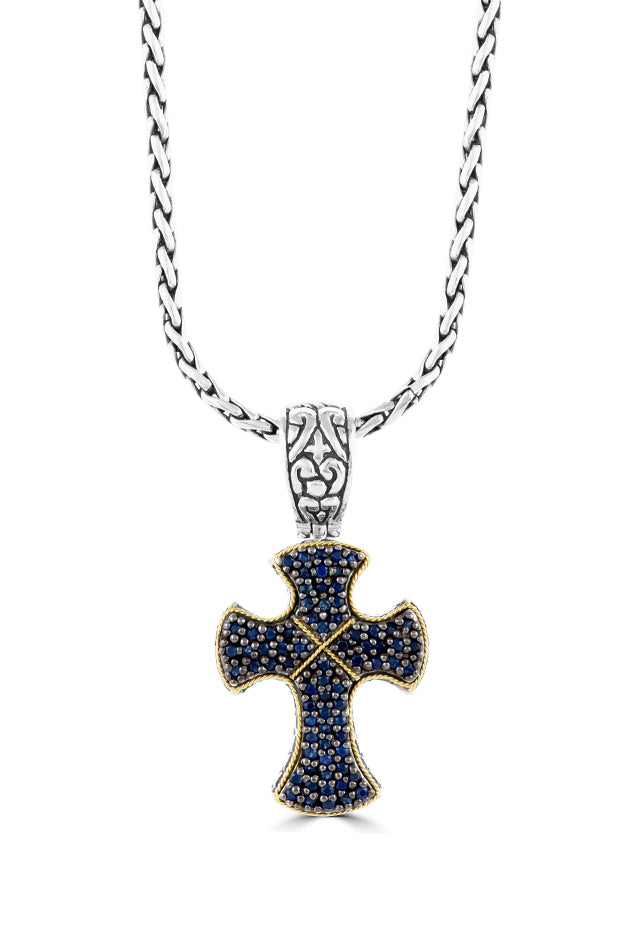 Sterling Silver & 18K Gold Blue Sapphire Cross Pendant, 0.88 TCW features an ornate cross with rounded edges, gold accents, blue sapphires, and detailed bail on a sterling silver chain necklace.