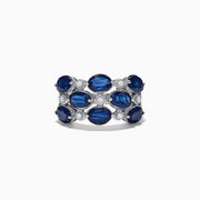 This elegant 14K white gold ring features alternating oval blue sapphires and round white diamonds, totaling 4.66 carats, for a striking look.