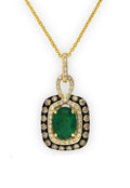The Gemma Emerald, Espresso & White Diamond Pendant features a rectangular gold design with a large oval emerald centerpiece, surrounded by two rows of white and brown diamonds and finished with an ornate diamond-studded bail.