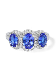 A 14K white gold ring showcasing three oval-cut tanzanites, each encircled by sparkling diamonds, with a total carat weight of 2.35.