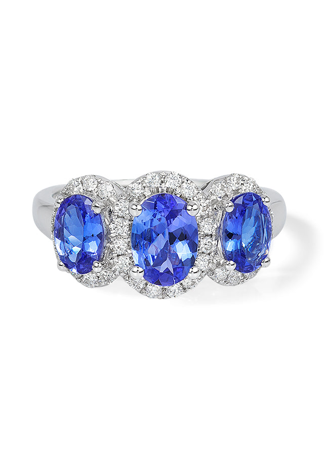 A 14K white gold ring showcasing three oval-cut tanzanites, each encircled by sparkling diamonds, with a total carat weight of 2.35.
