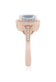 The Aquarius 14K Rose Gold Aquamarine and Diamond Ring, 3.10 TCW, showcases a cushion-cut aquamarine center, haloed by sparkling white diamonds and detailed band accents for an elegant finish.