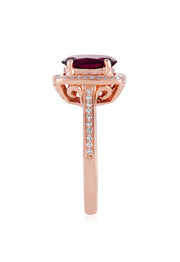 The Bordeaux 14K Rose Gold Rhodolite Garnet and Diamond Ring, 2.48 TCW showcases a large oval rhodolite garnet, double haloed by white diamonds, with additional diamond accents along the band.